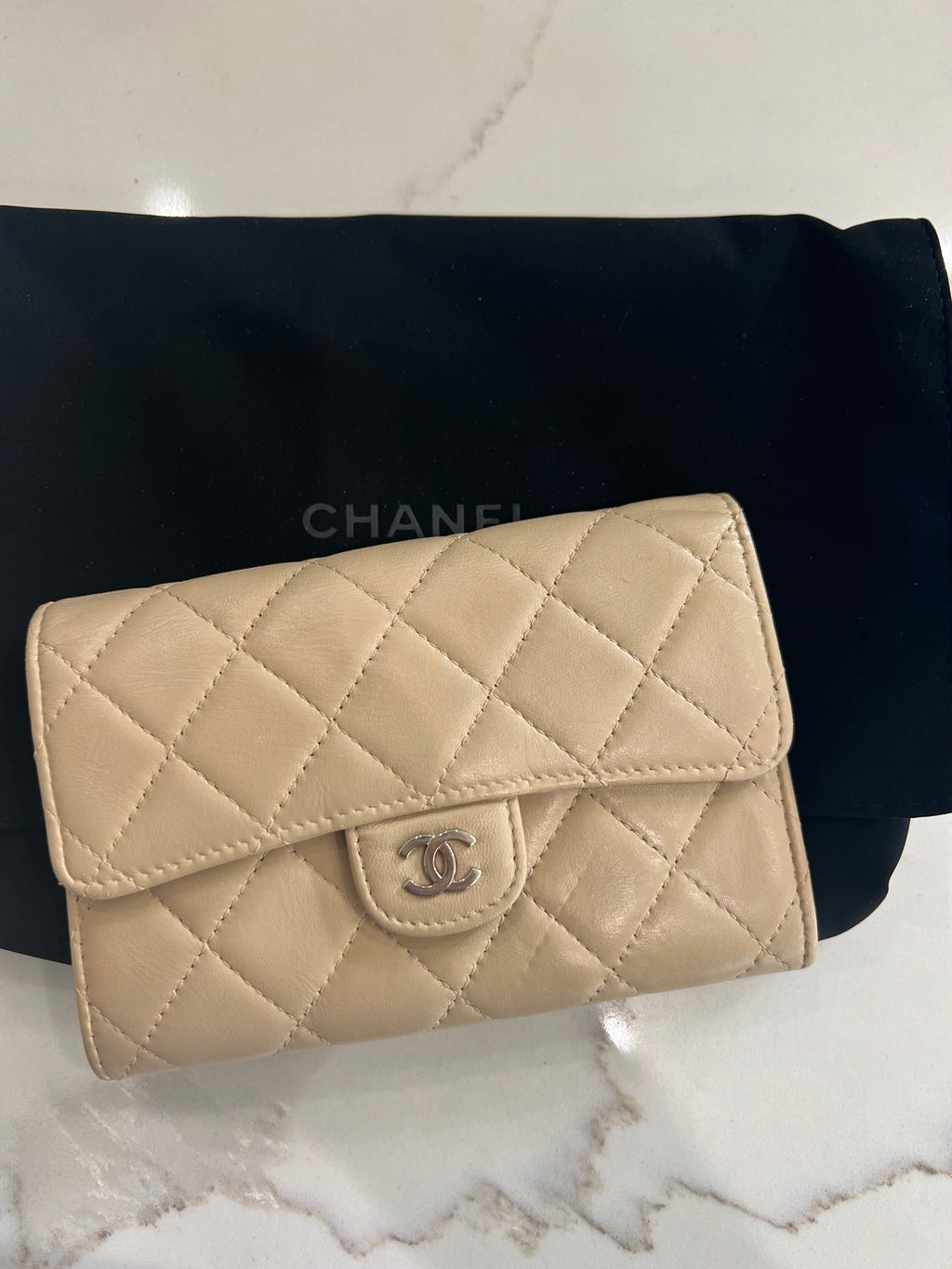 Beige gusseted Chanel timeless wallet on chain