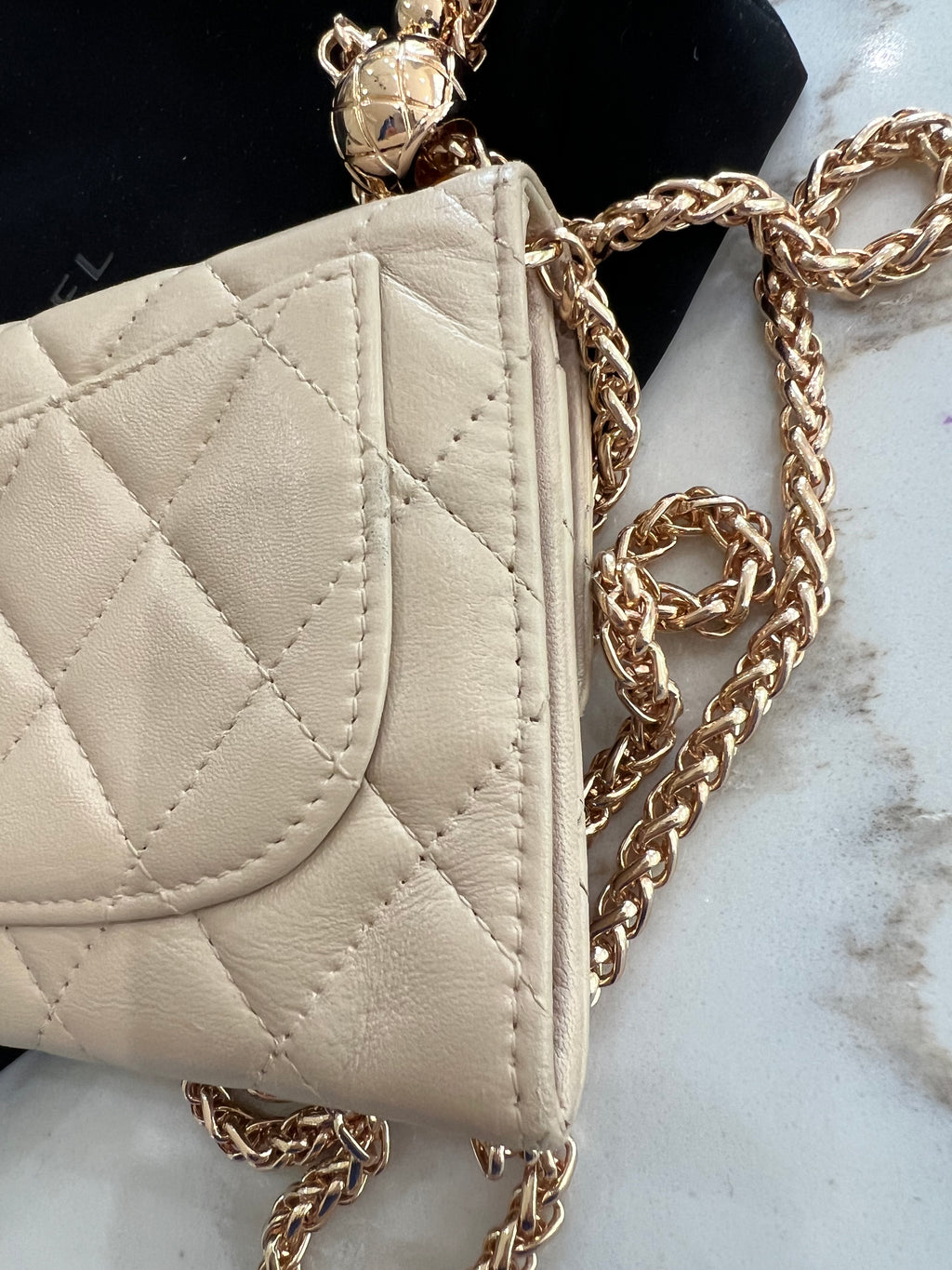 Beige gusseted Chanel timeless wallet on chain